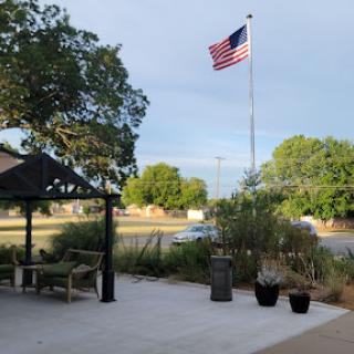 A serene outdoor space featuring an American flag waving in the breeze.