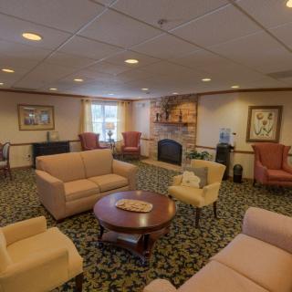 A cozy lounge area with sofas, chairs, and a coffee table.