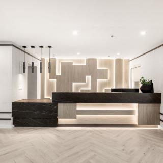 A sleek, modern reception area with minimalist design and ambient lighting.