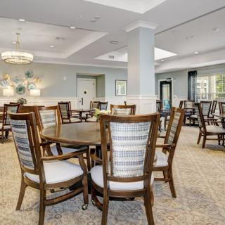 A modern, spacious dining area with elegant furniture arrangement.