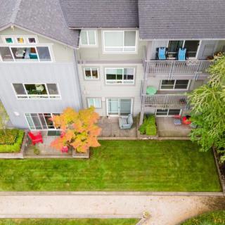Aerial view of a residential apartment building with balconies and well-maintained lawns.