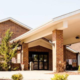 A brick building with a covered entrance.