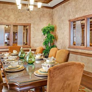 A traditional dining room with a classic table setting and elegant decor.