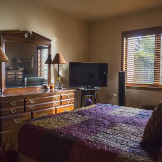 A cozy bedroom with vintage furniture and warm lighting.