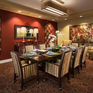 A luxurious dining room with an elegant table setting and sophisticated decor.