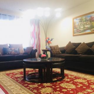 A cozy living room with comfortable sofas and a decorative rug.