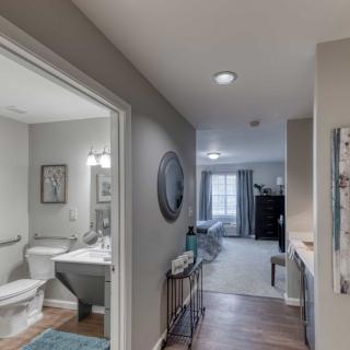 A cozy hallway leading to a bathroom and bedroom in a modern home.