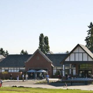A spacious outdoor area with people gathered near a building, showcasing traditional architecture.
