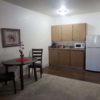 A compact kitchen area with a small dining table setup.