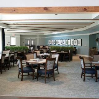 A spacious restaurant dining area with neatly arranged tables and chairs.