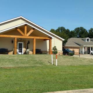 A suburban house with a well-maintained lawn and driveway.
