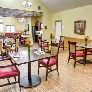 A cozy dining area with neatly arranged tables and chairs in a well-lit restaurant.