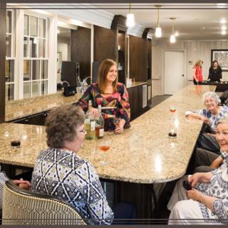 A group of people enjoying a social gathering at an indoor bar counter.