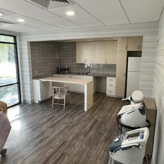 A modern kitchen featuring sleek cabinetry and wood flooring.