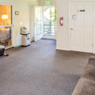 A spacious and bright lobby area with an open door letting in natural light.