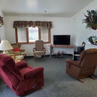 A cozy living room with comfortable seating and a television.