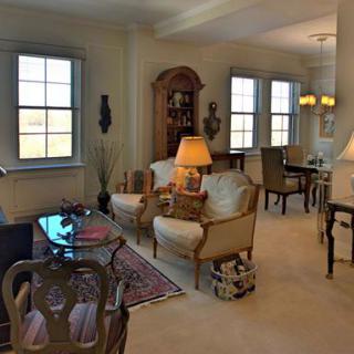 A cozy living room with classic furniture and warm lighting.