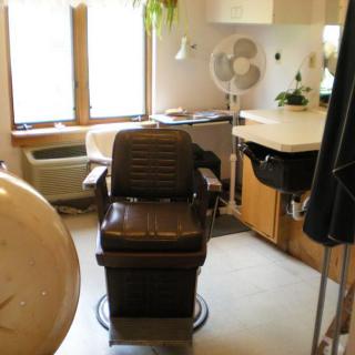 A vintage barber chair in a quaint salon setting.