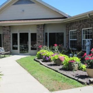 A building with a beautifully landscaped garden and pathway.