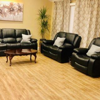 A cozy living room with leather seating and a wooden coffee table.