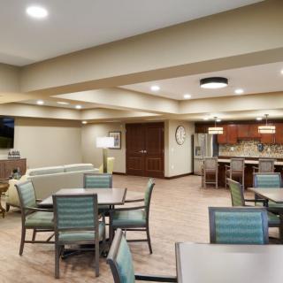 A modern kitchen and dining area with contemporary furniture and lighting.