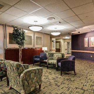 A cozy waiting area featuring comfortable seating and soft lighting, ideal for relaxation.