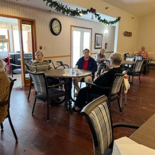 Seniors enjoying a social gathering in a cozy dining area.