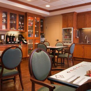 A cozy dining area with elegant wooden furniture and neatly arranged tables.