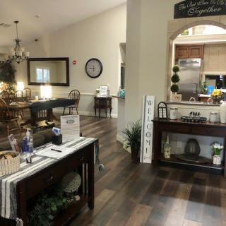A cozy and well-decorated living and dining area with wooden floors, featuring elegant furniture and warm lighting.