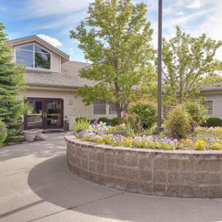 A beautifully landscaped garden surrounding a modern building.