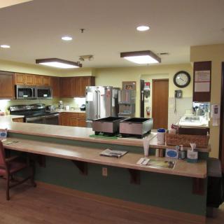 A modern kitchen with a spacious countertop and various appliances.