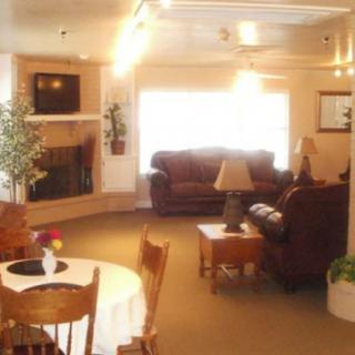 A cozy living room with comfortable seating, a fireplace, and dining area.