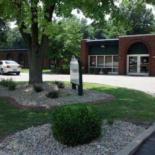 A well-maintained commercial building with landscaped surroundings.
