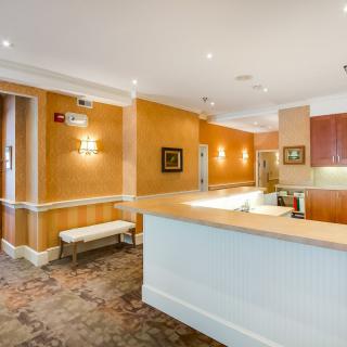 A well-lit reception area with a front desk and seating.