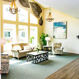 A bright and inviting living room featuring modern furniture, elegant lighting, and decorative elements.