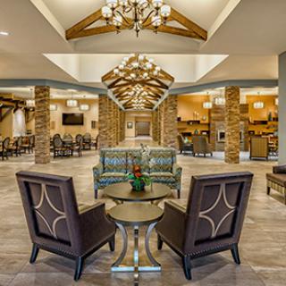 A stylish and welcoming lobby featuring modern furnishings and elegant chandeliers.