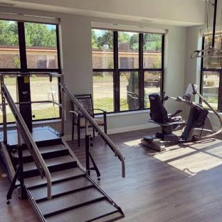 A bright and modern gym space equipped for rehabilitation and fitness training.