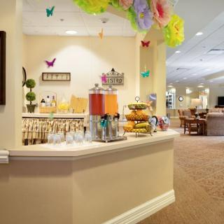 A brightly decorated refreshment bar featuring a variety of drinks and snacks.