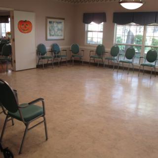 An empty meeting room with chairs arranged in a circle.