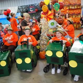 Children in creative costumes participate in a lively fall festival parade.