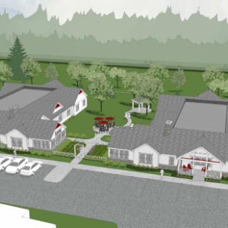 Aerial view of a small community with several buildings and landscaped surroundings.