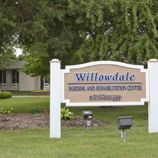 Sign for Willowdale Nursing and Rehabilitation Center surrounded by greenery.