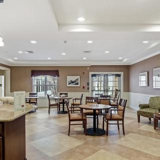 A cozy dining area with tables and chairs, well-lit and inviting.