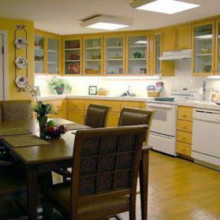 A modern kitchen with wooden cabinets and a dining area.