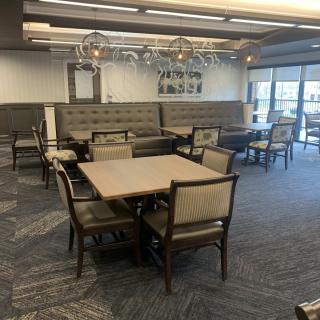 A modern dining area with neatly arranged tables and chairs.