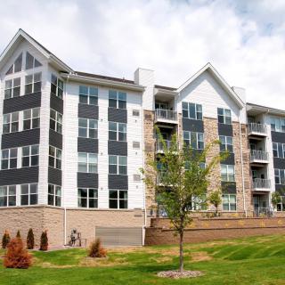 A modern apartment complex with landscaped surroundings.