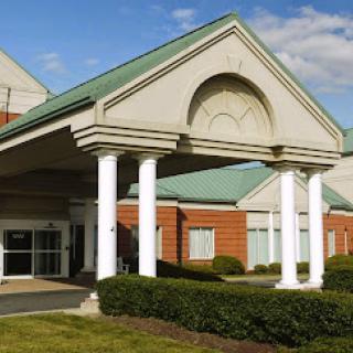 The entrance of a modern building featuring classic architectural elements.