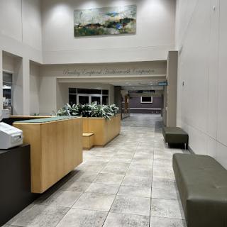 A spacious and modern lobby featuring a reception desk and seating areas.