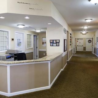 A spacious office reception area with a hallway and modern interior design.