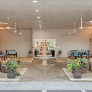 A spacious lobby entrance featuring seating areas and decorative plants.